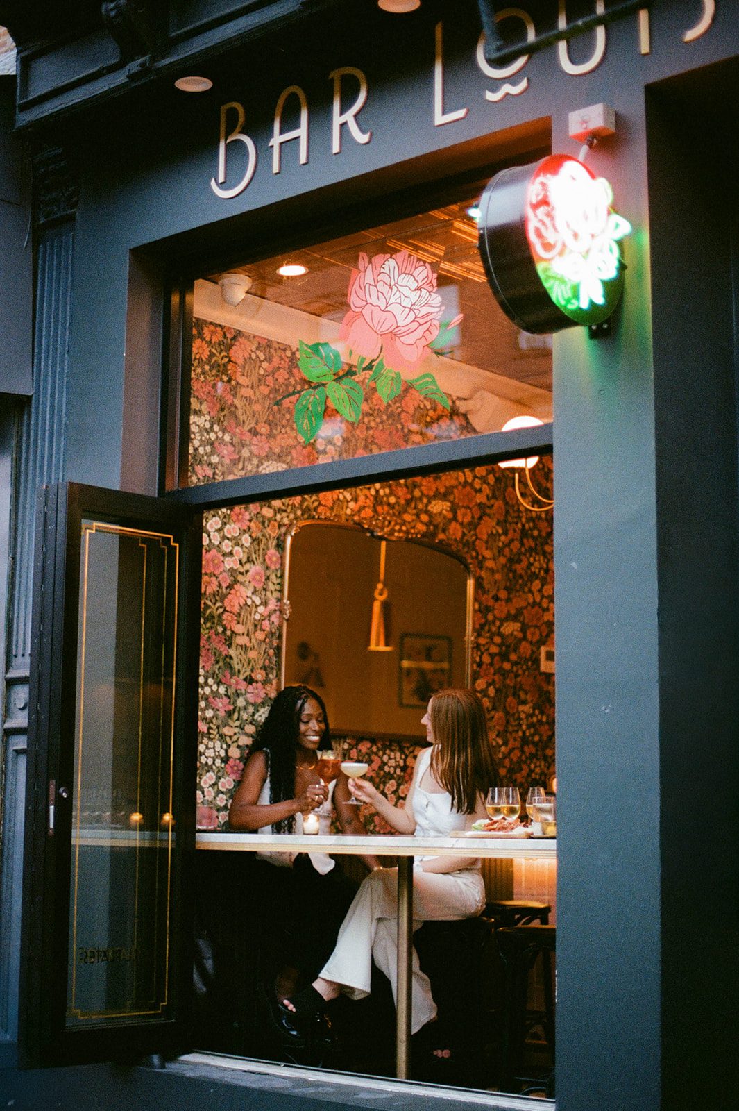 Cassia and Laura seated in the window at Bar Louise in Park Slope