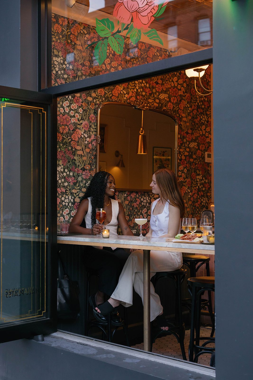 Exterior of Bar Louise on 7th Avenue in Park Slope with Cassia and Laura at the window