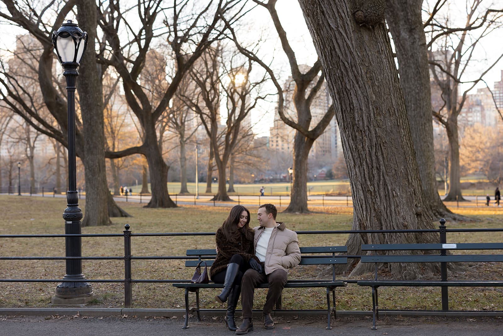Carlie and Mat sitting close together on a Central Park bench