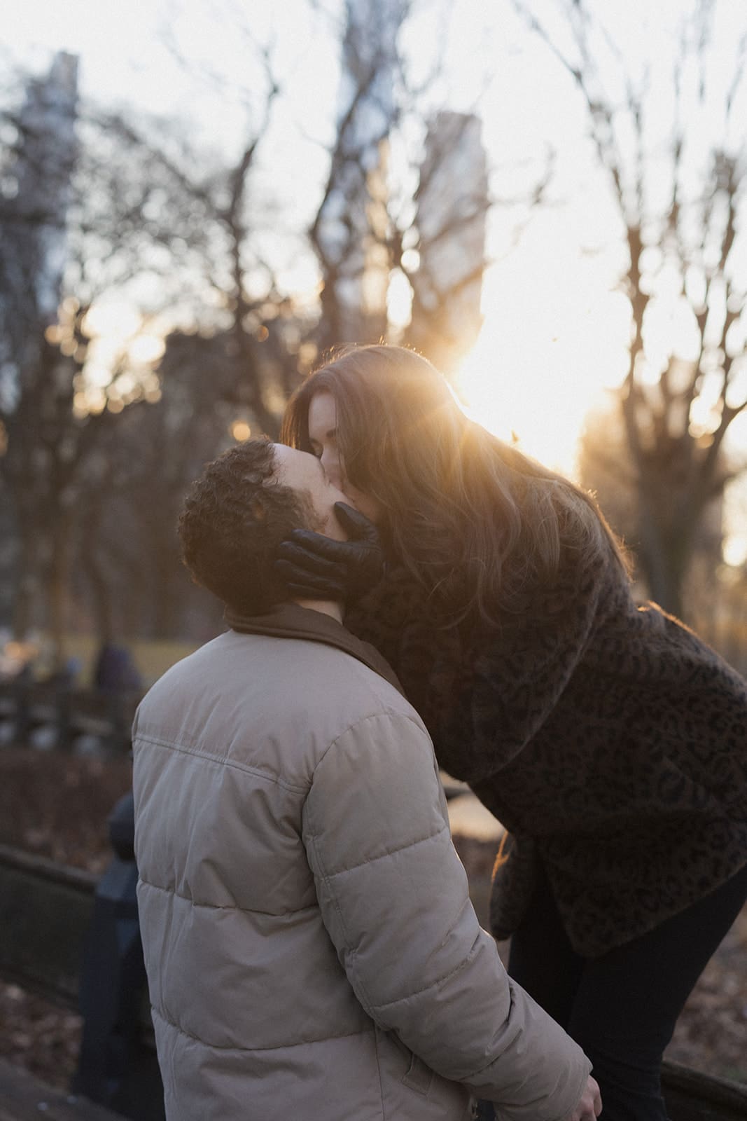 Carlie and Mat sharing a quiet moment in the low winter sunlight in Central Park