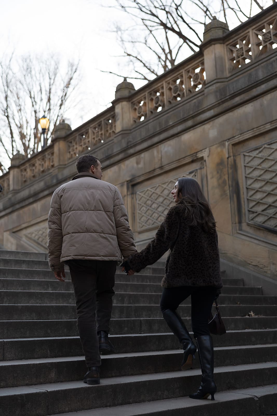Carlie and Mat on the Bethesda Terrace stairs in their winter coats