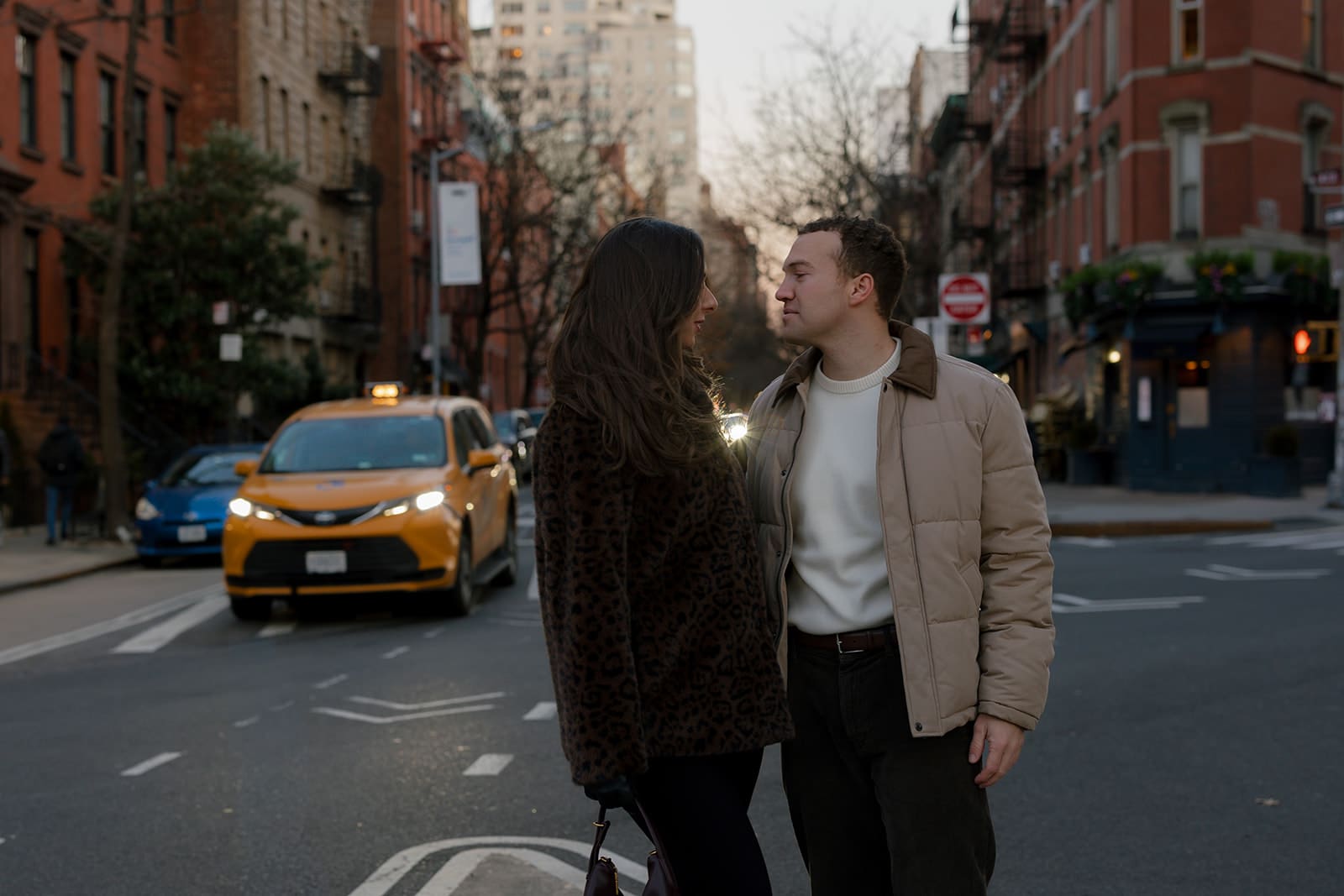 Carlie and Mat crossing a New York street together at dusk