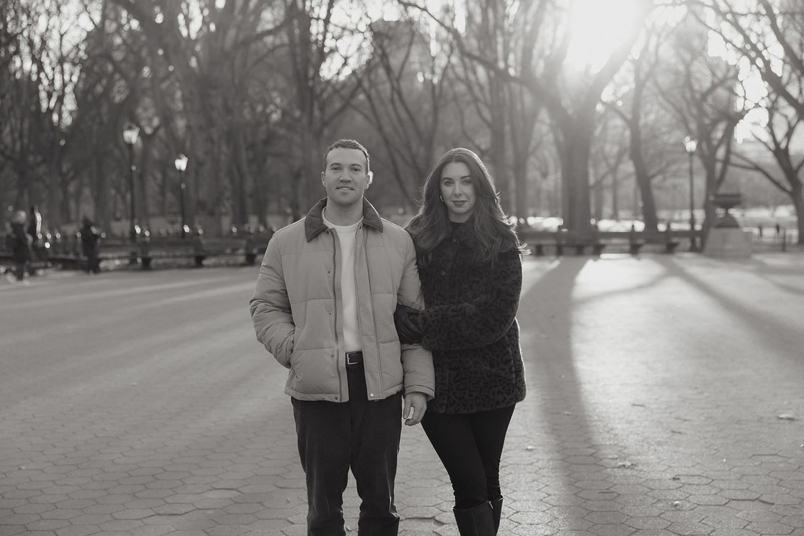 Winter portrait of Carlie and Mat beneath the bare trees of Central Park