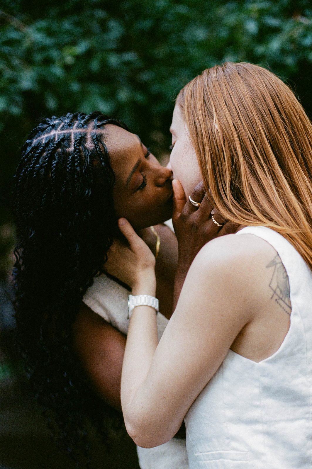 Cassia and Laura kissing on a Park Slope sidewalk photographed on 35mm film