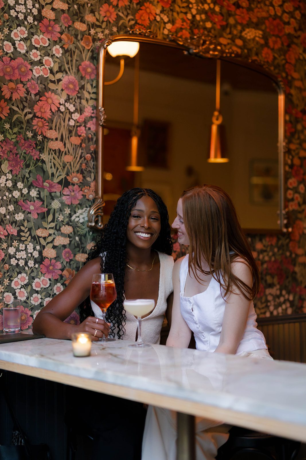 Cassia and Laura sharing cocktails at a cozy Park Slope wine bar