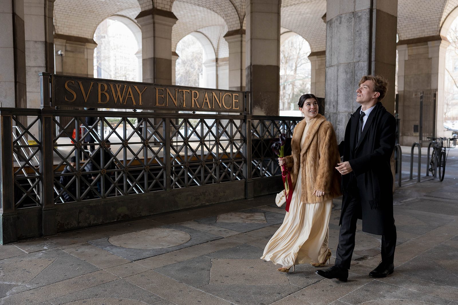 Claire and Andrey walking past Chambers Street Station after their City Hall elopement
