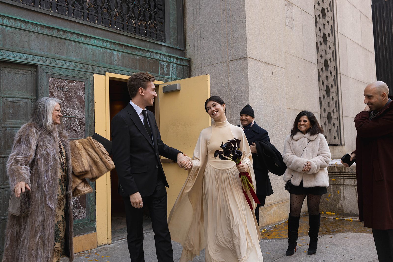 Claire and Andrey leaving City Hall with their family after the ceremony