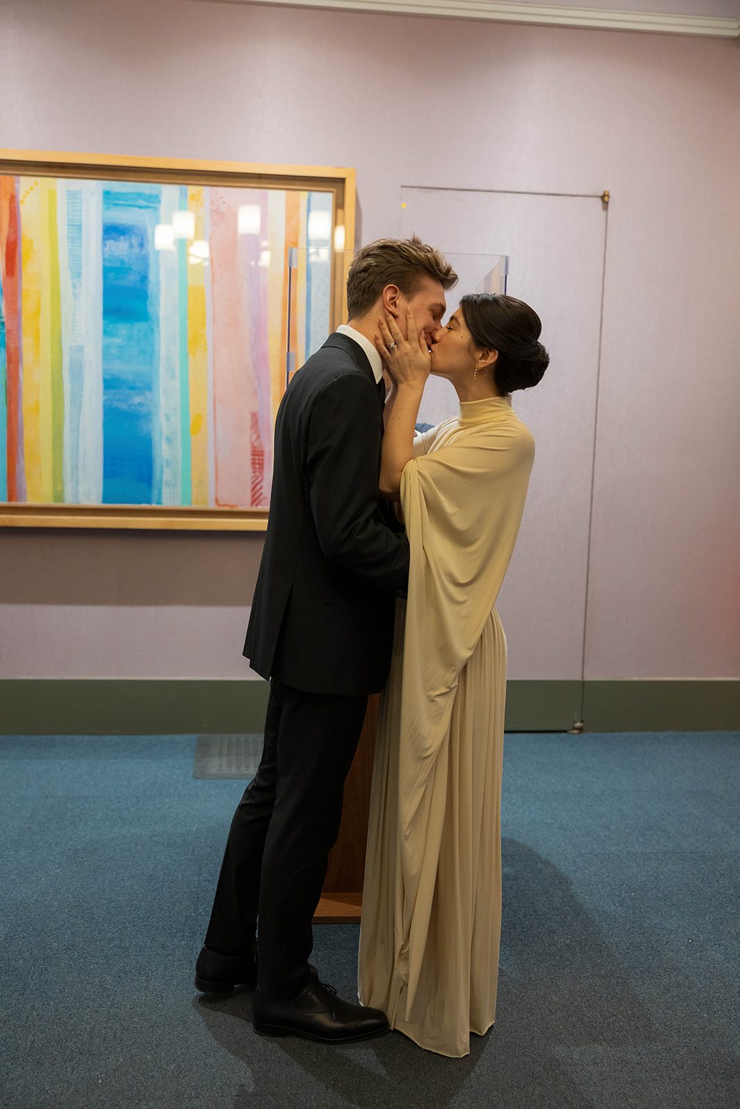 Claire and Andrey sharing a kiss after their City Hall ceremony