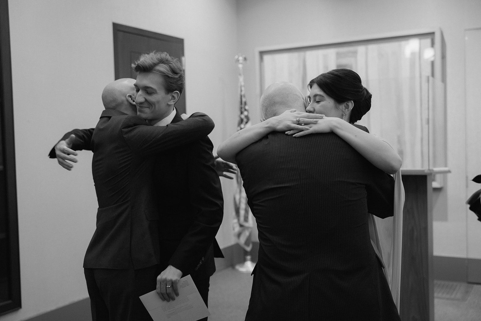 A family hug after Claire and Andrey's New York City Hall wedding ceremony