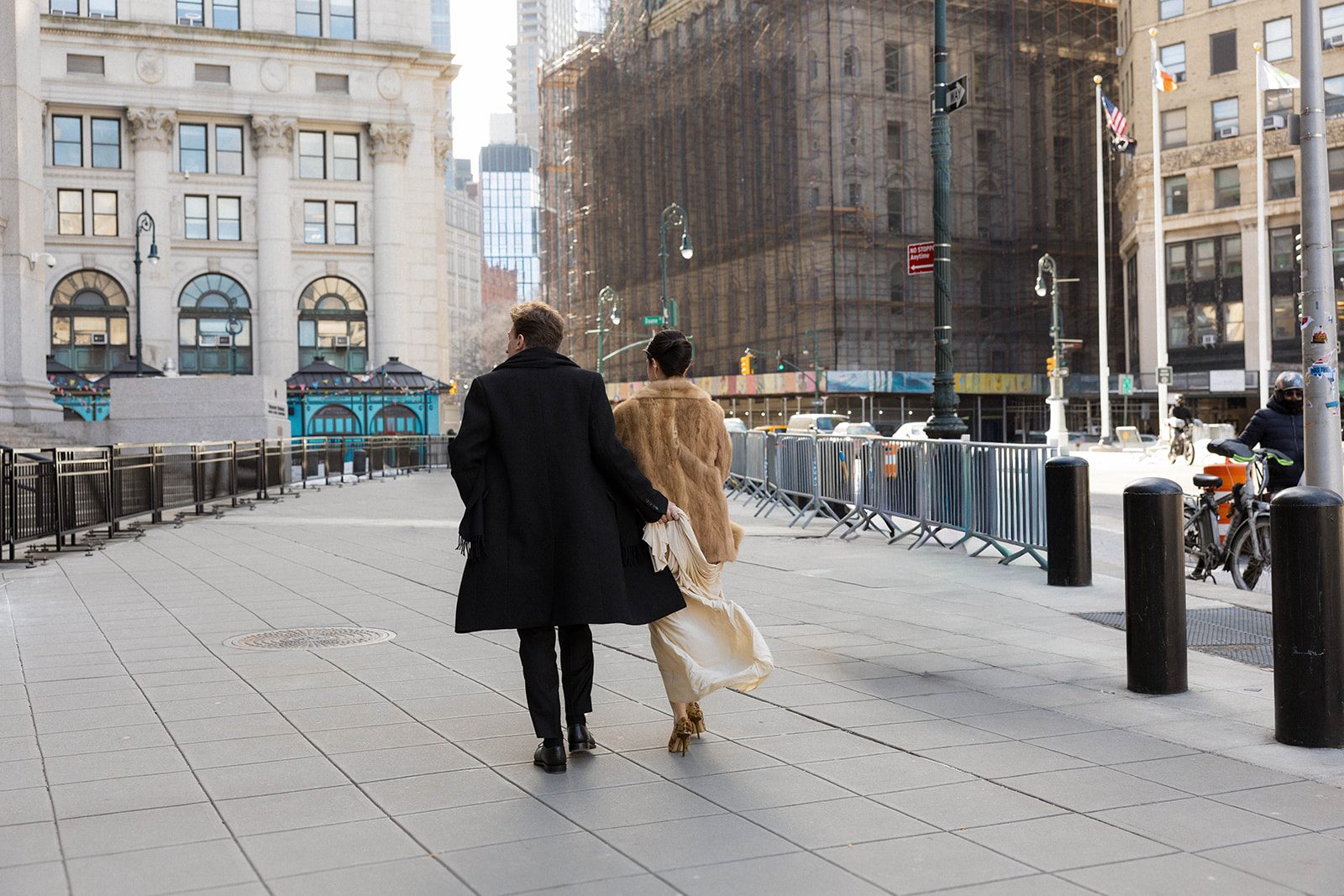 Claire and Andrey walking from City Hall toward the subway after their elopement