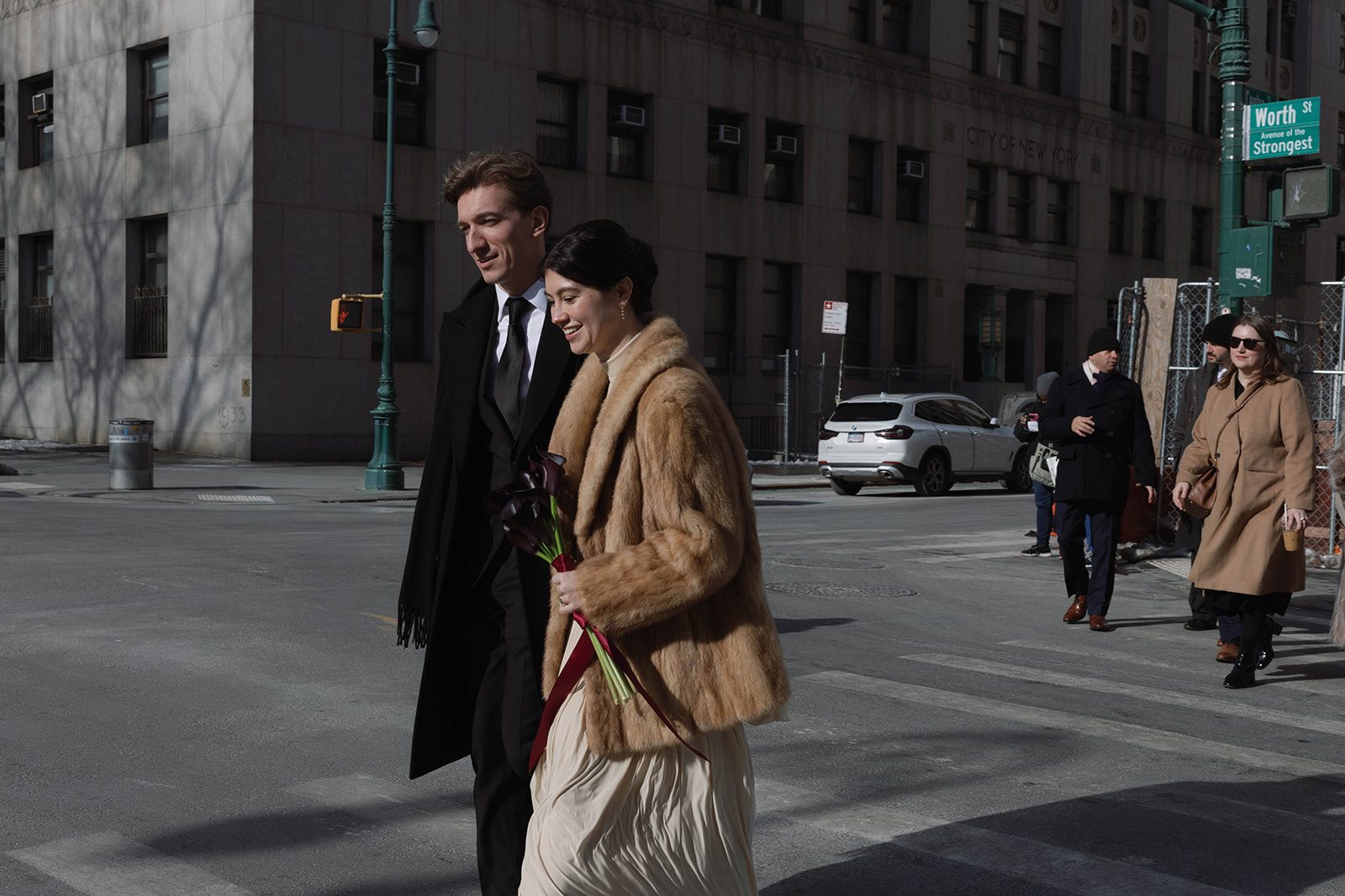 Claire and Andrey walking through Lower Manhattan after their City Hall wedding