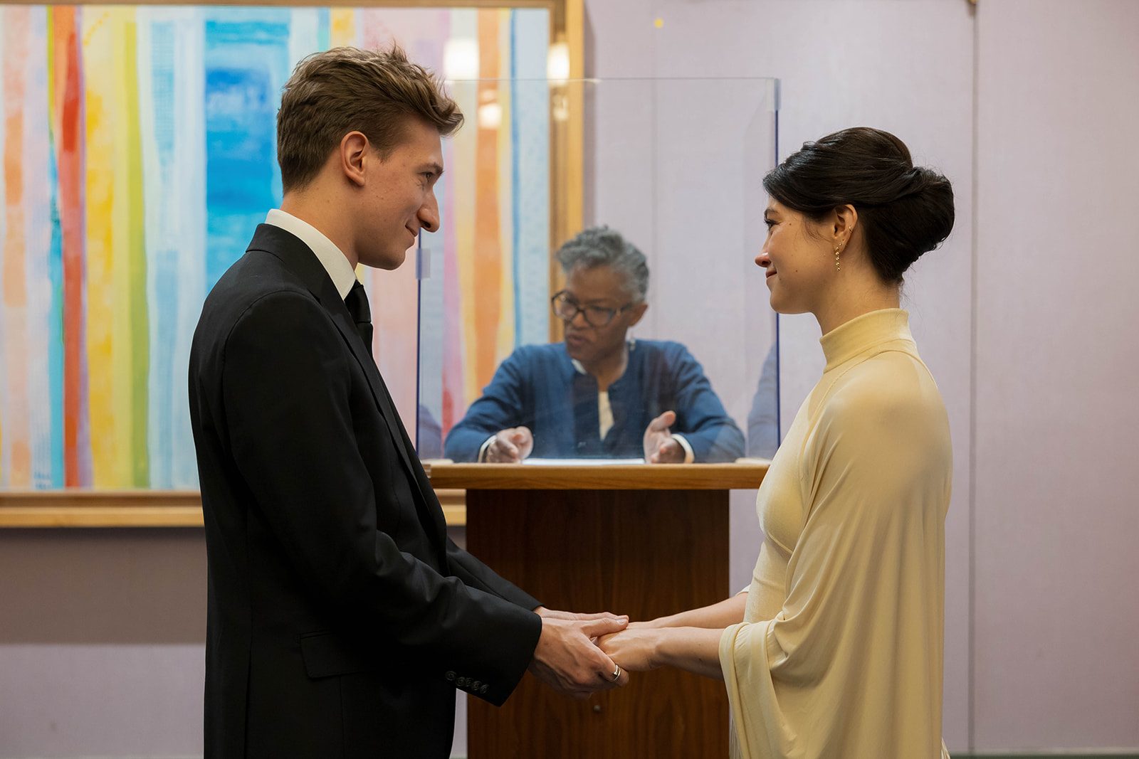 Claire and Andrey holding hands during their New York City Hall ceremony