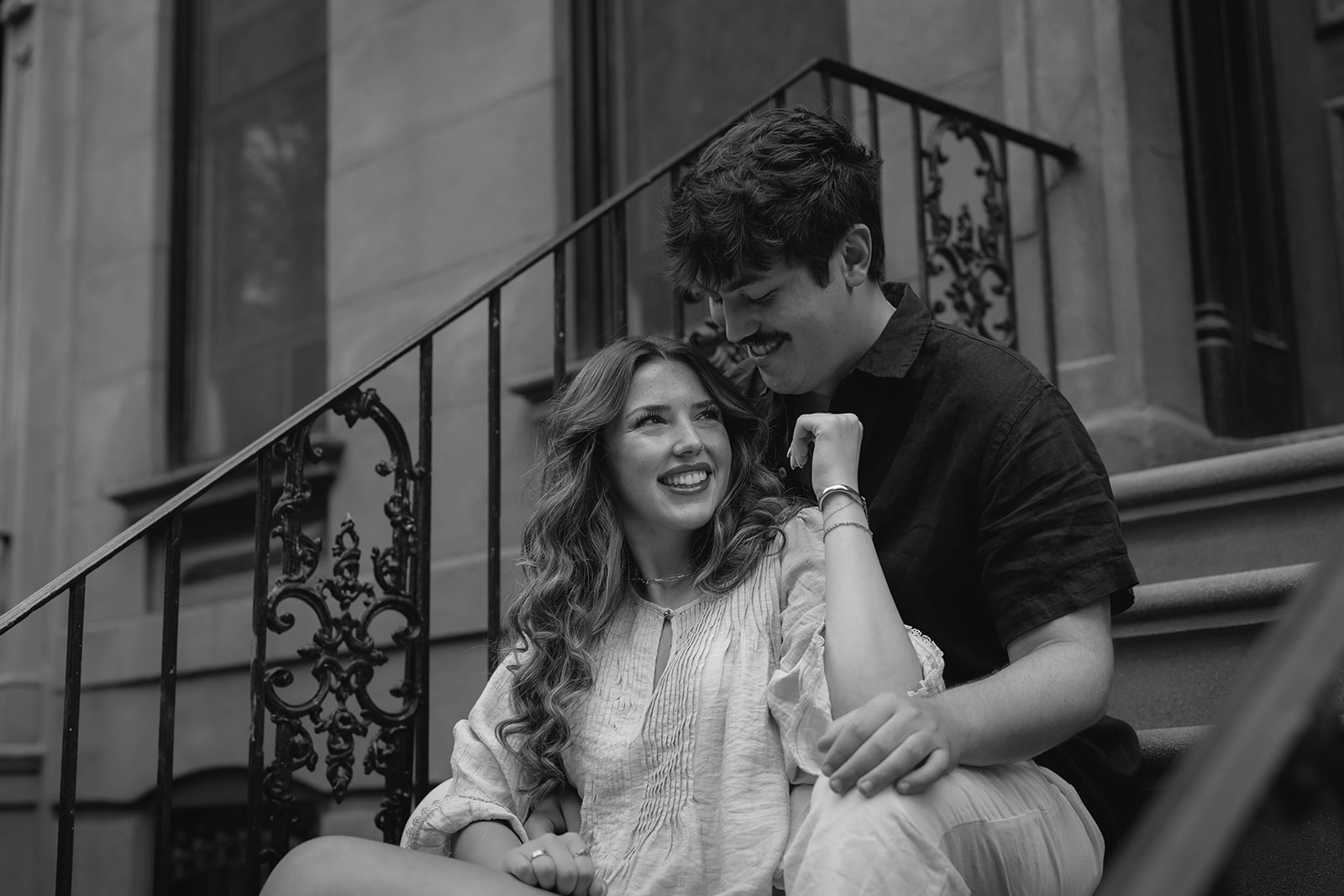 Sadie laughing with David on his grandparents’ Brooklyn brownstone stoop